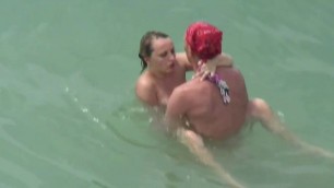 Sex on the beach. Two couples fuck in the water.