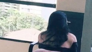 asian tranny stroking her big cock in her hotel balcony